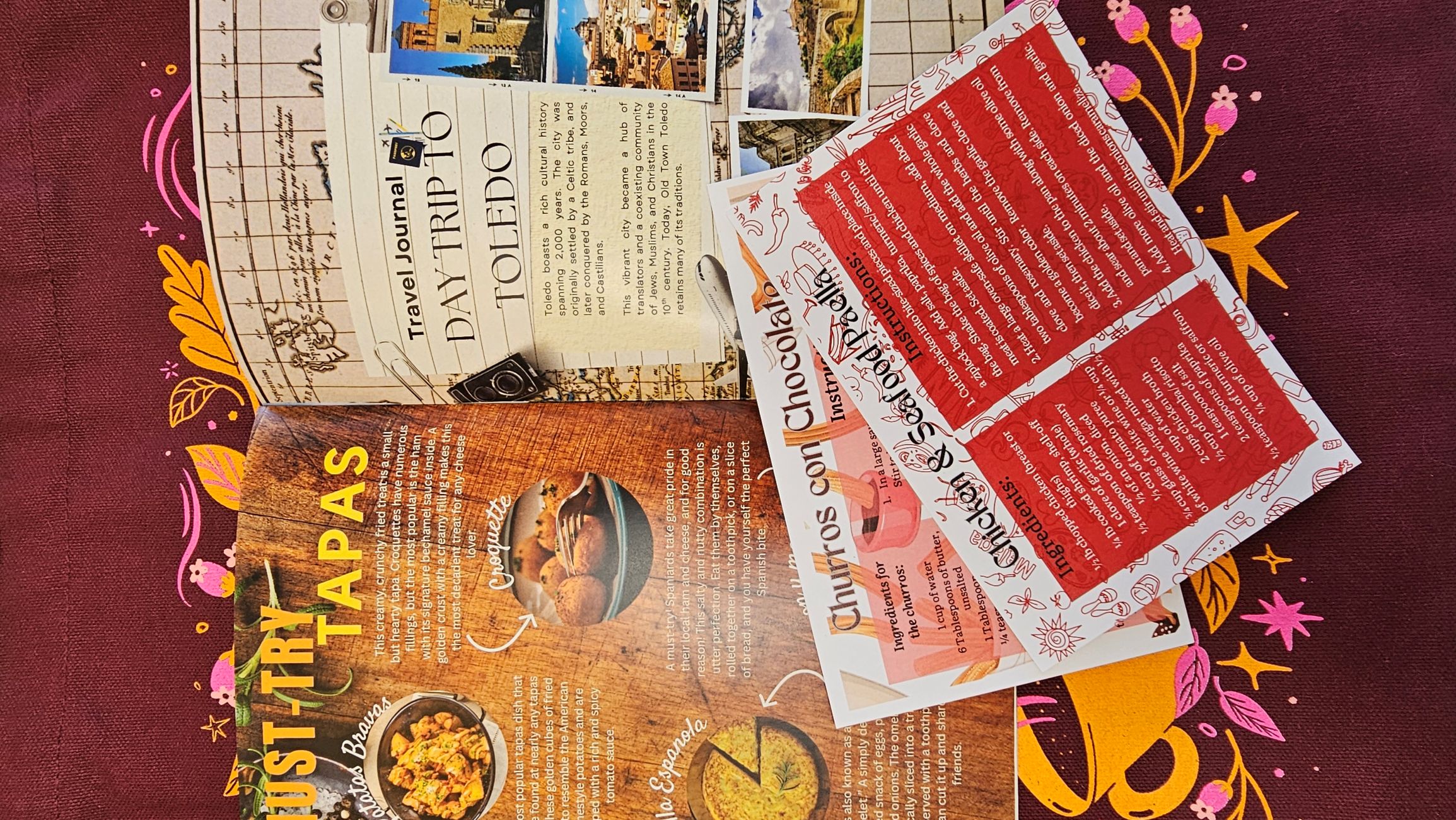 Spain guidebook open to a page about Tapas and a Paella and Churros recipe cards are pictured as well. 