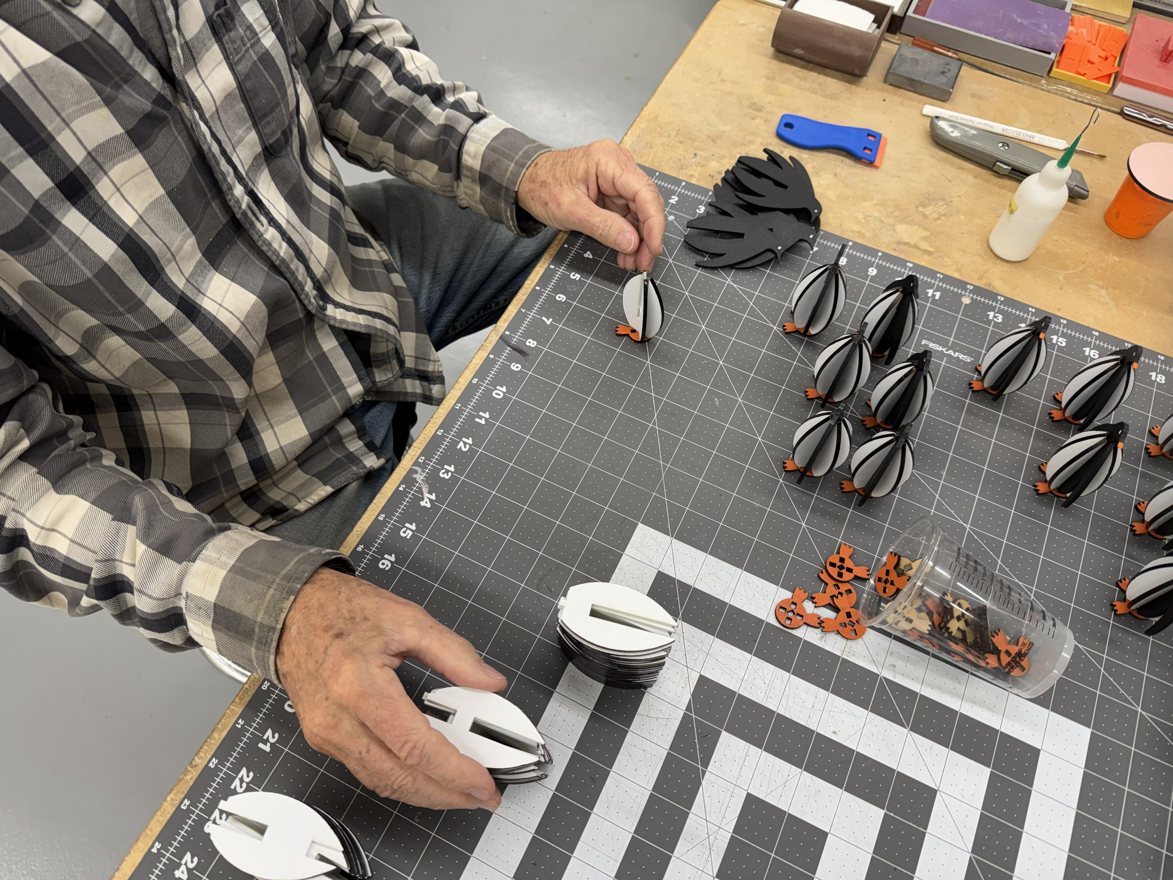 Building wooden penguins in our home workshop for our Antarctica boxes