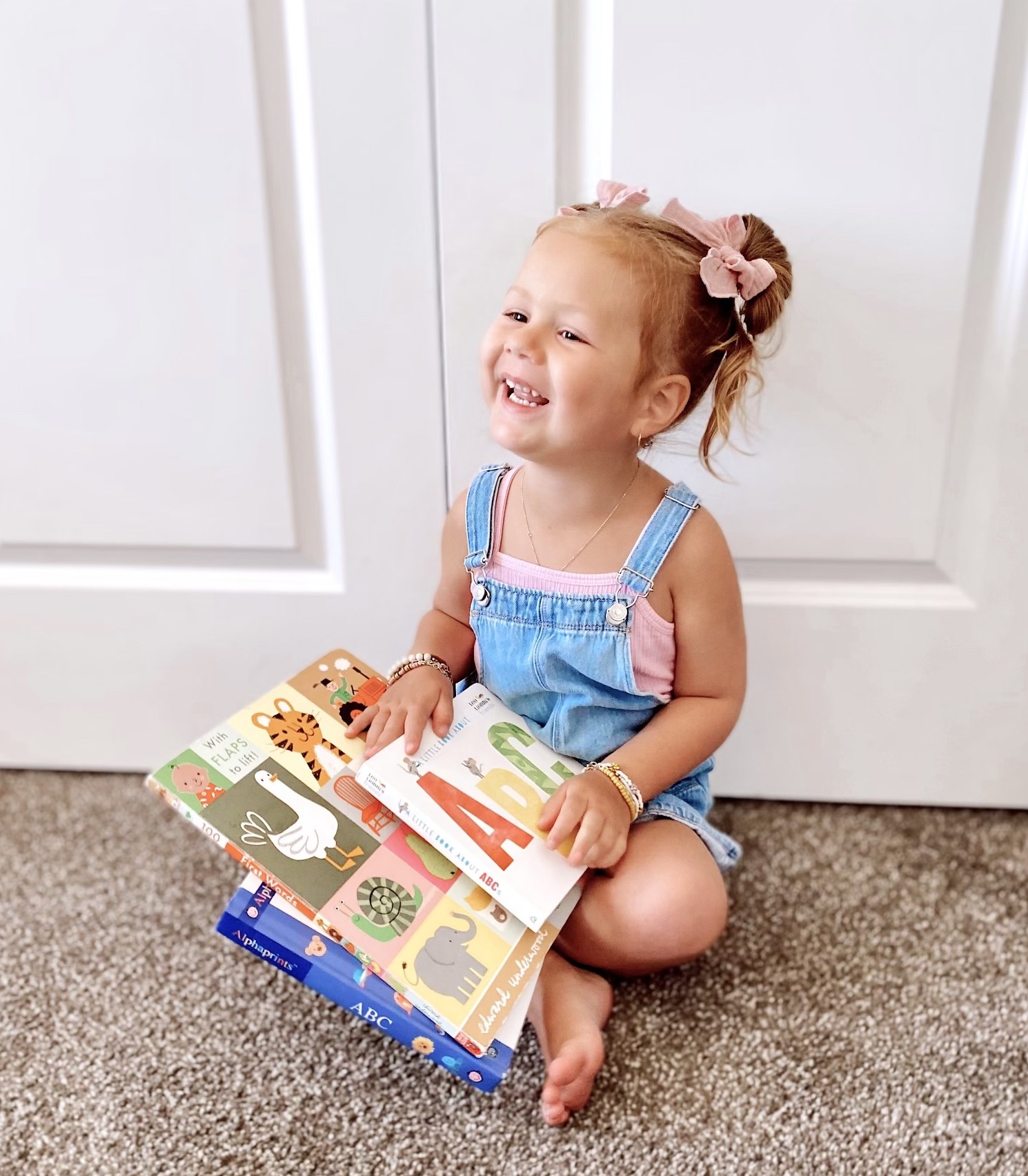 99314901705172-nora-smiling-with-books-edited.jpg