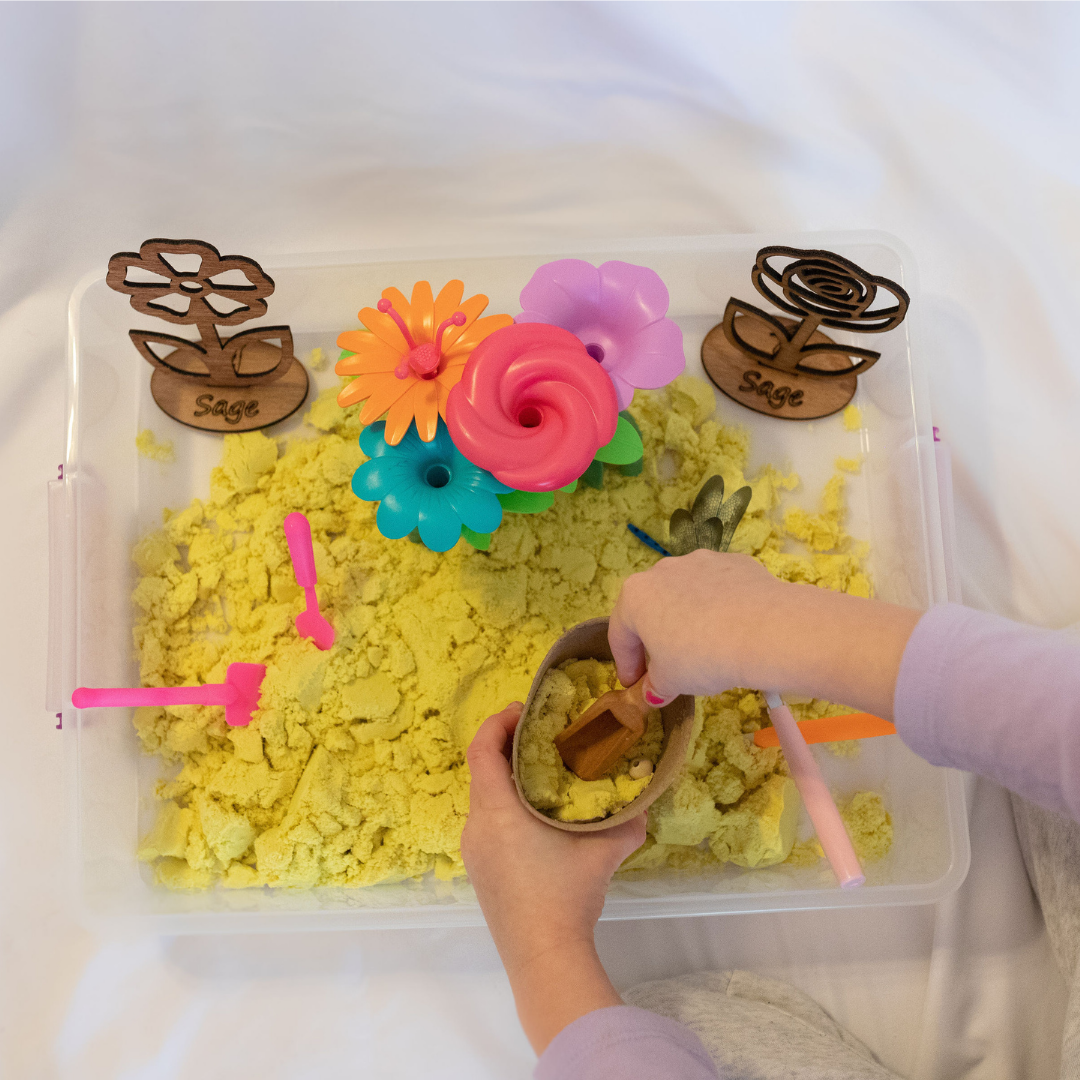 Scooping sand with Flower Sensory Kit