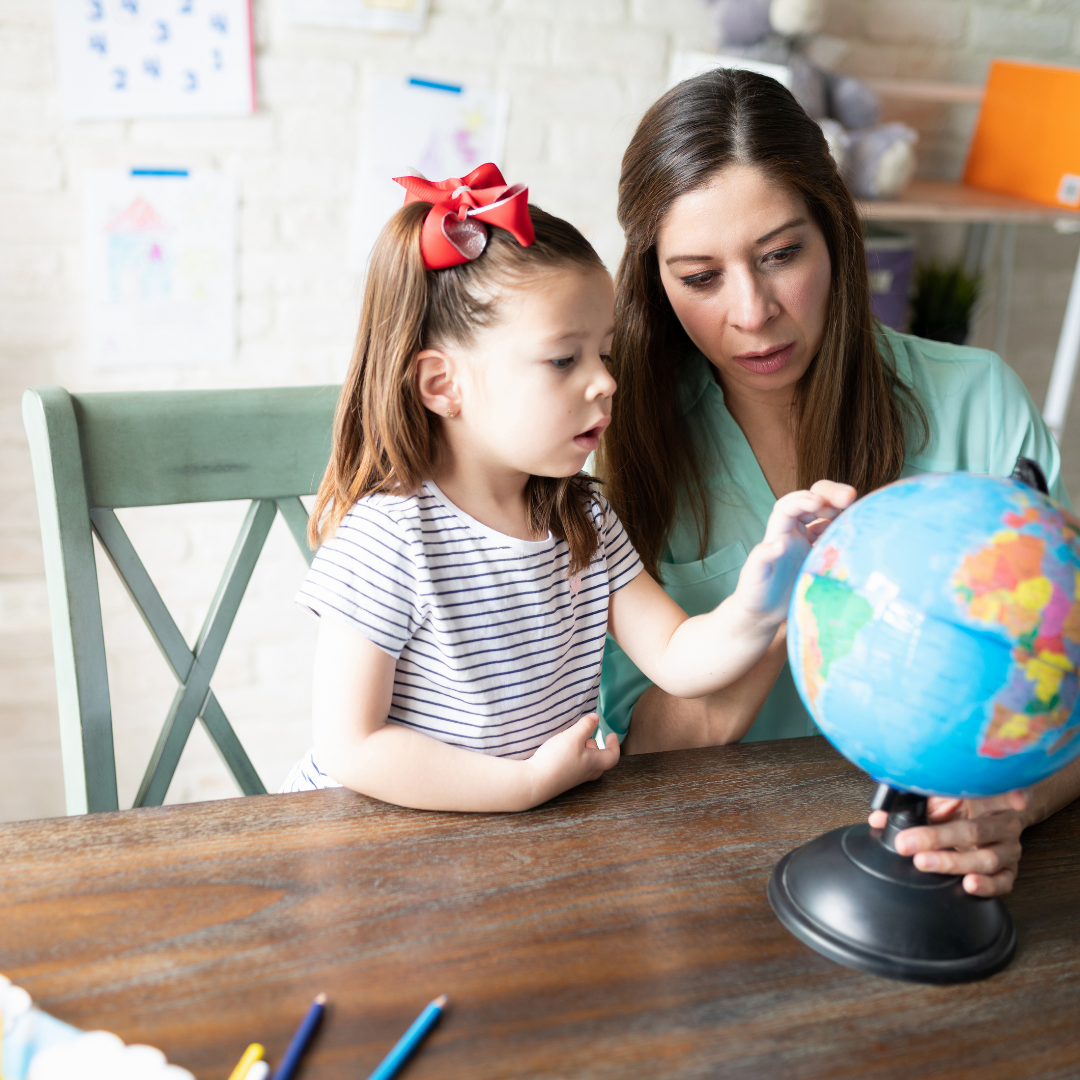 Mom and Daughter looking at a globe