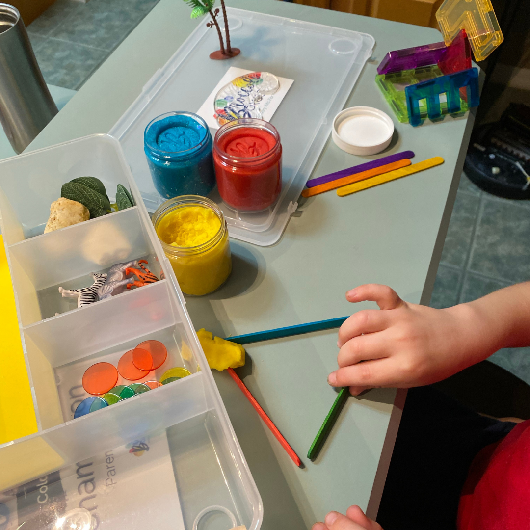 Creating shapes with craft sticks and sensory dough