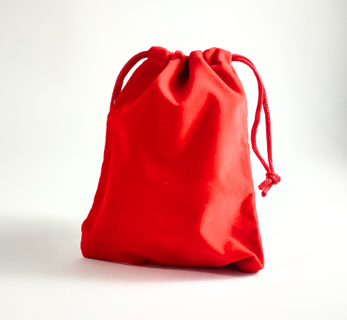 Red velvet bag filled with game pieces to create a game