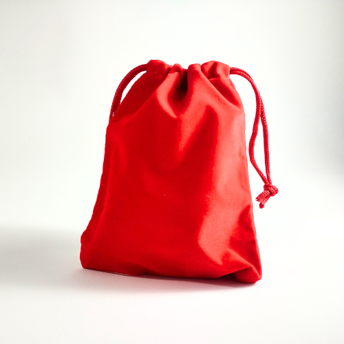 Red velvet bag filled with game pieces to create a game