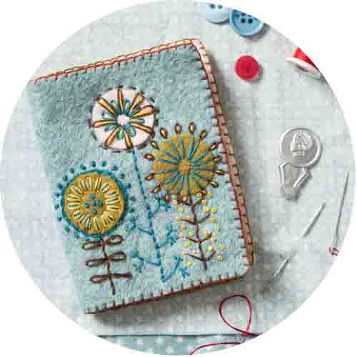 Light blue felt needle case with folk style embroidery