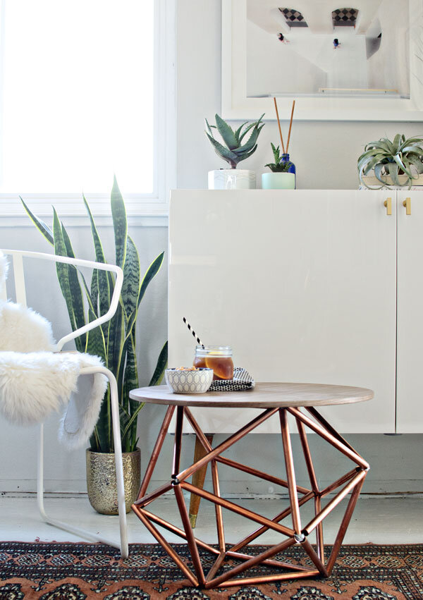 Image depicting a small, stylish himmeli coffee table with copper pipes.