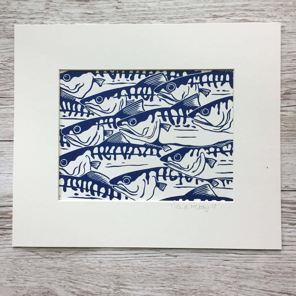 Blue and white print of a school of fish