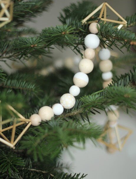 A close-up shot of a himelli bead garland placed decoratively on a Christmas tree.