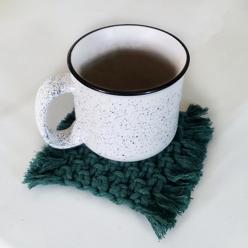 mug sitting on a green macrame coaster