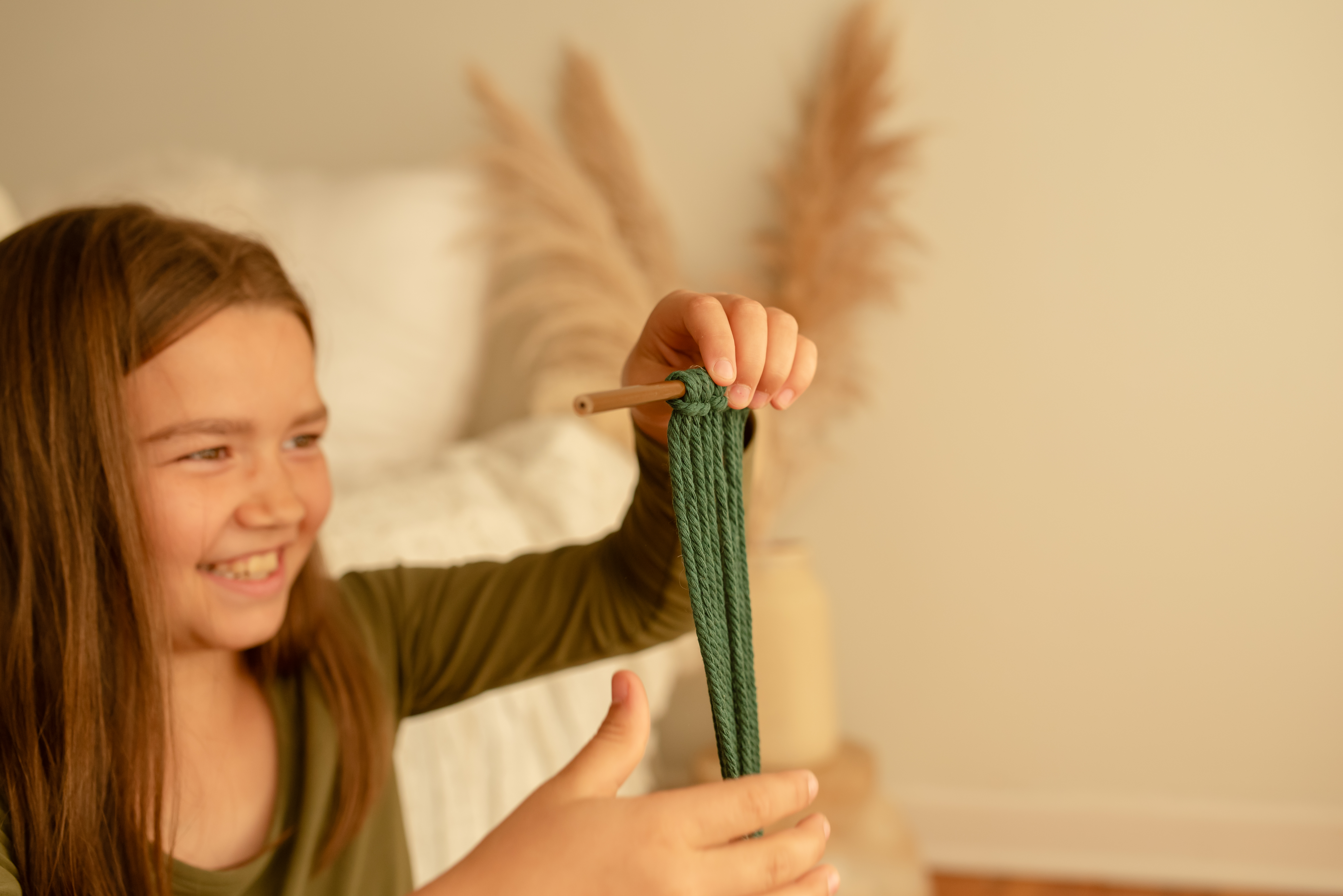 child creating a macrame project