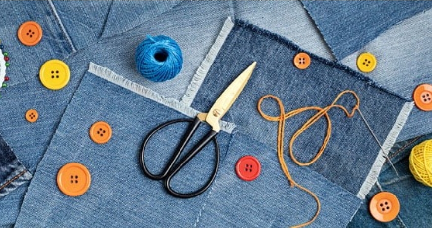 buttons and other sewing notions on a background of blue jeans