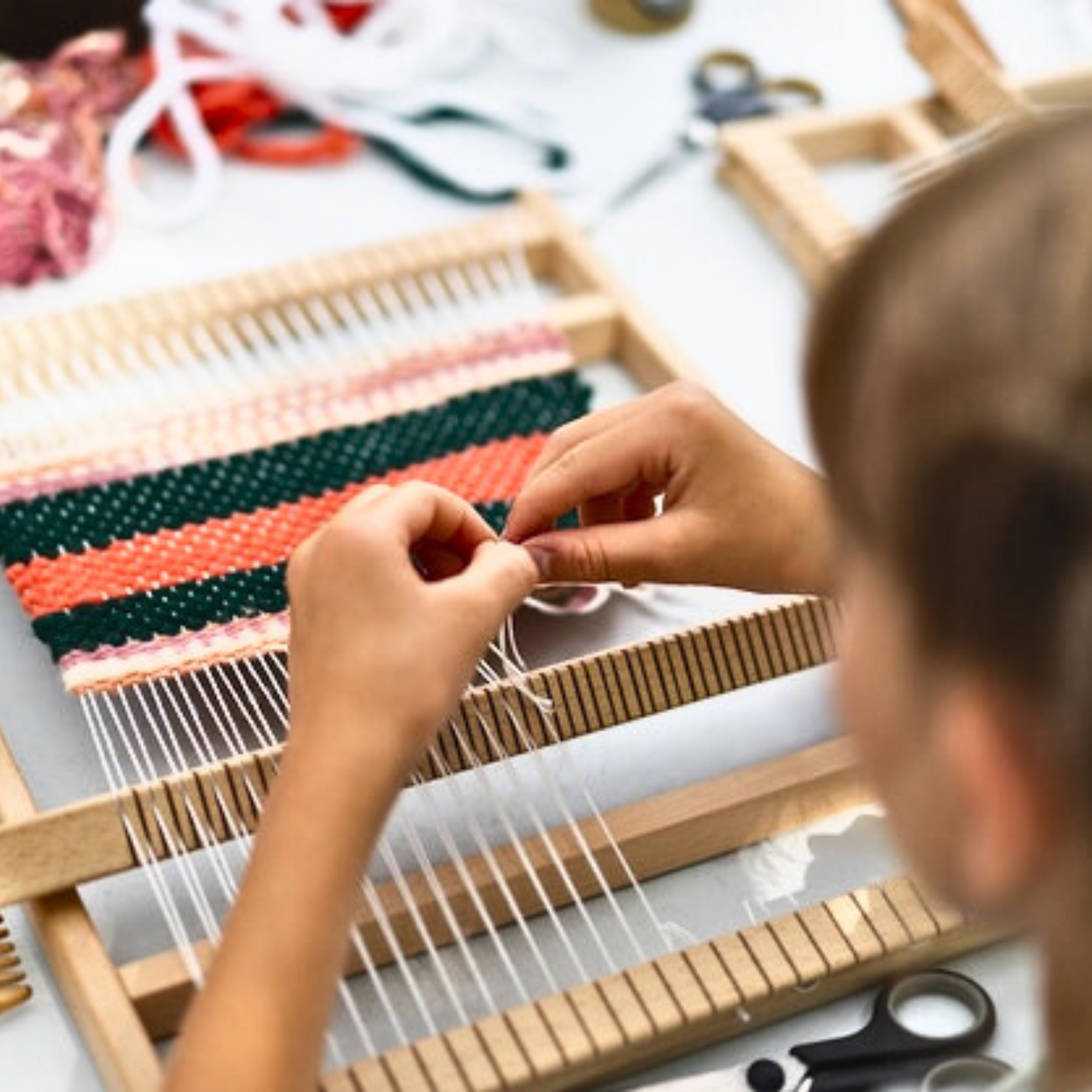 child weaving with a loom