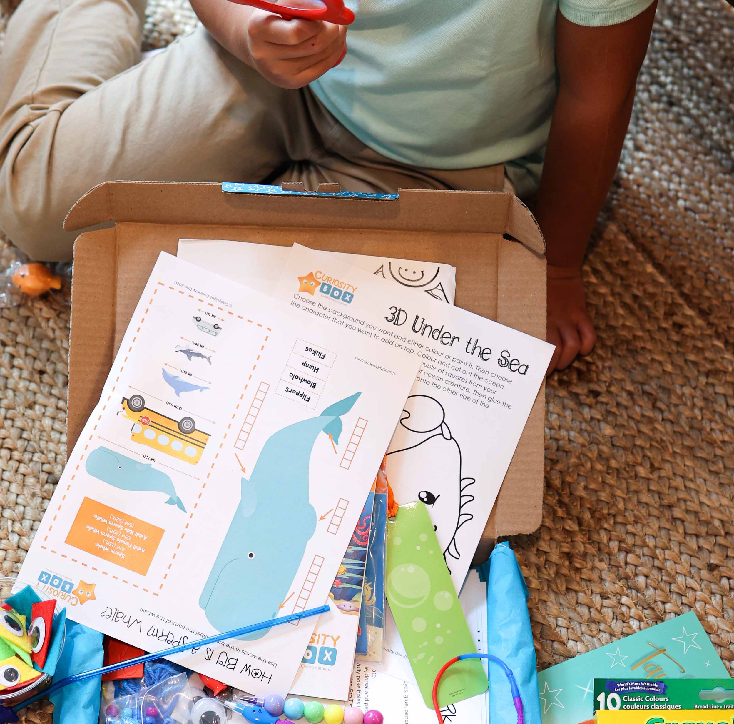 Kid playing with crafting box, Showing what is insde