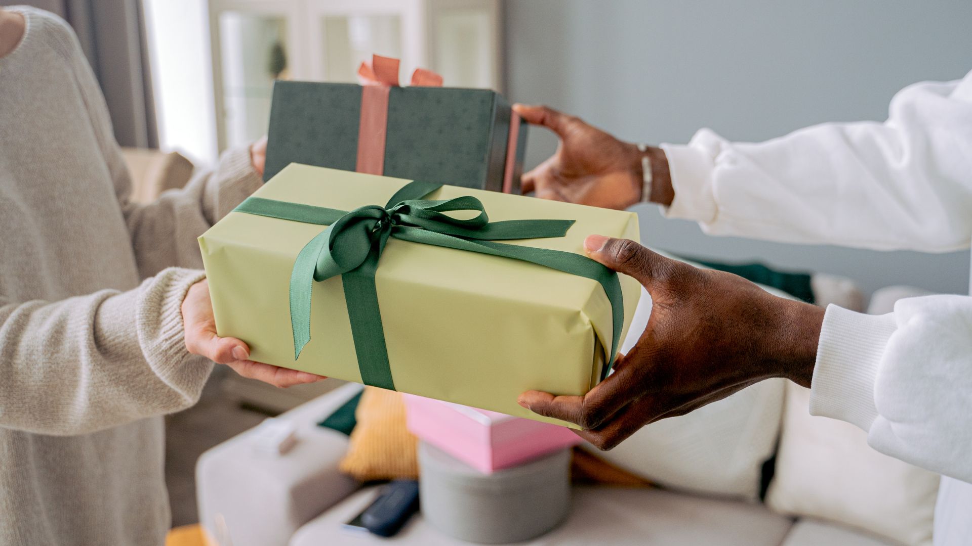 two people handing each other gifts