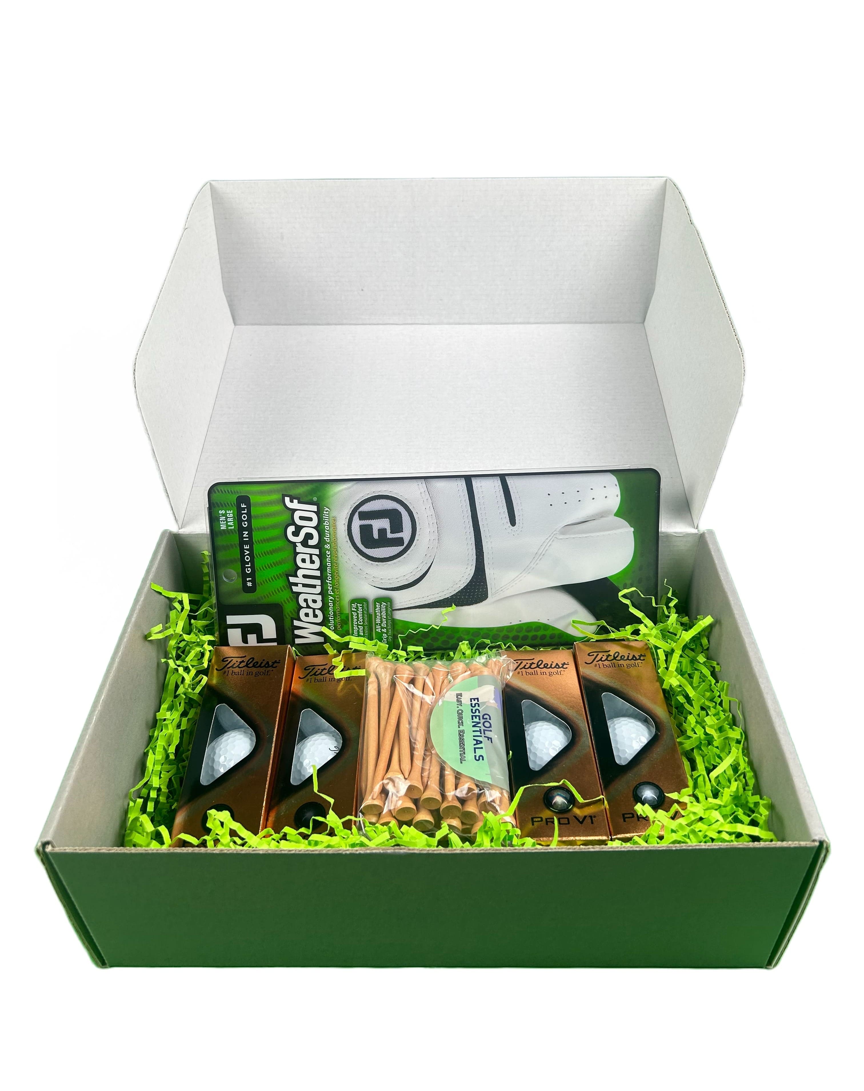 Golf Essentials box with prov1s and weathersof glove in the green grass filler.