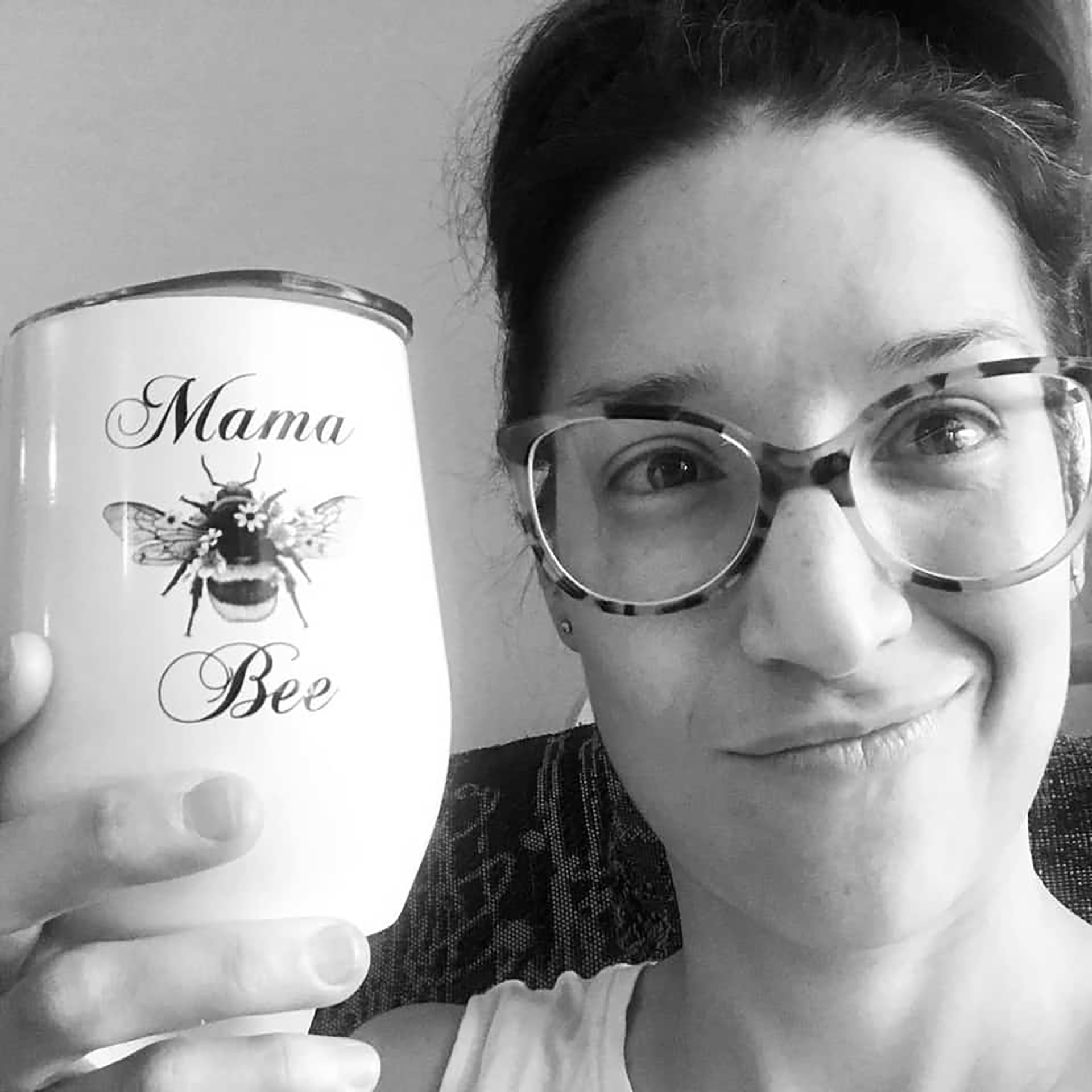 mom holding bee tumbler found in her subscription box for toddlers
