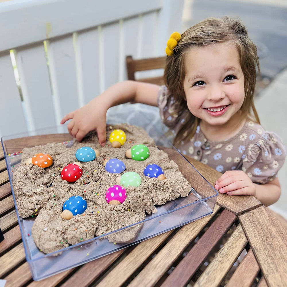 mommy and me subscription box little girl playing with wooden toys from Howdy Baby subscription box for mom, baby, and kids
