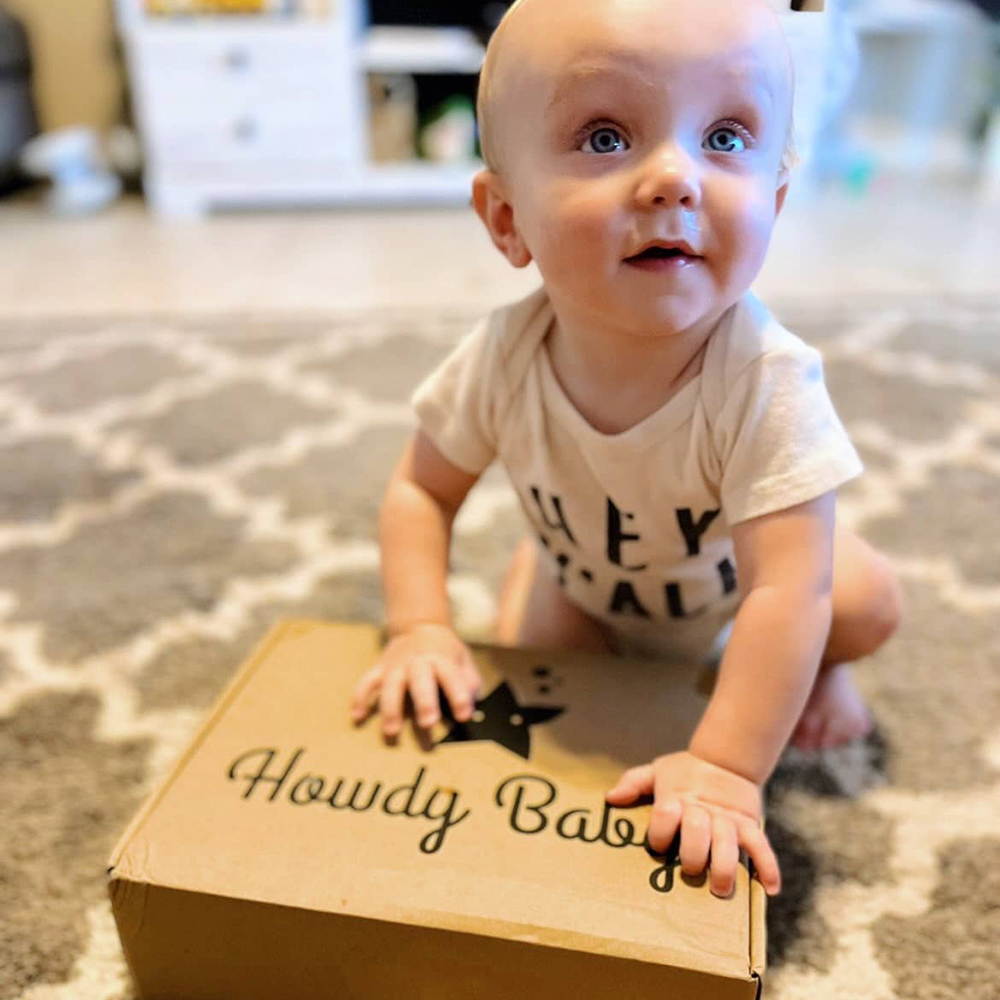 baby boy with the Howdy Baby subscription box for mom and baby