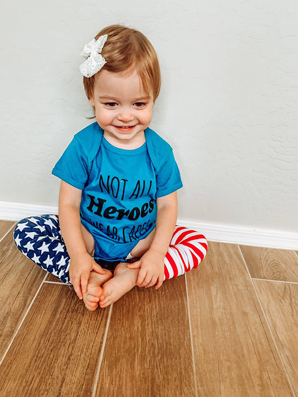 hero onesie and legwarmers featured in the July 2022 Howdy Baby activity box for toddlers
