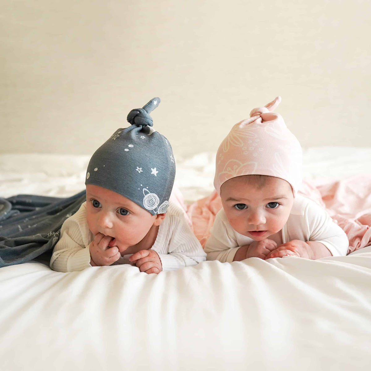 babies wearing knit top knot hats