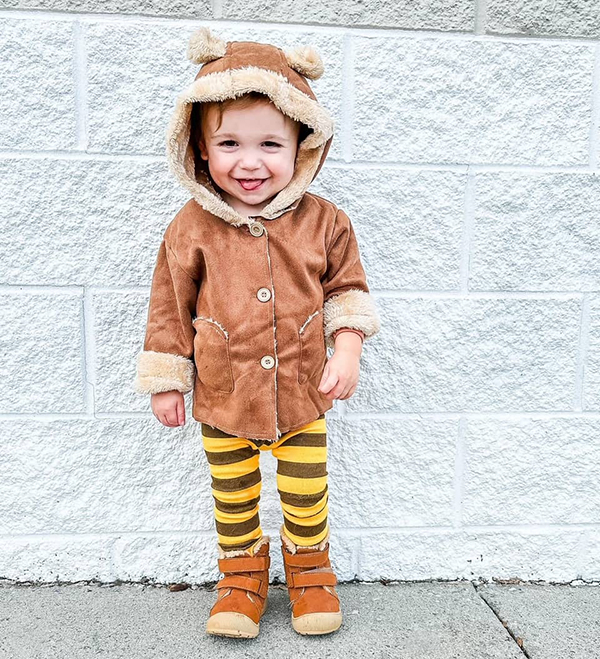 toddler wearing a brown suede bear ear hooded jacket from the November 2023 Howdy Baby Box subscription