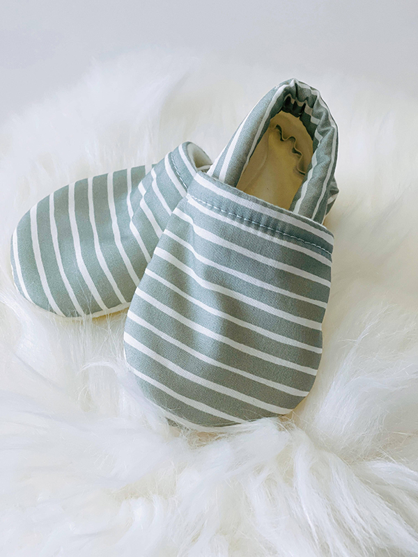 handmade green striped baby moccasins from Howdy Baby subscription box for toddlers