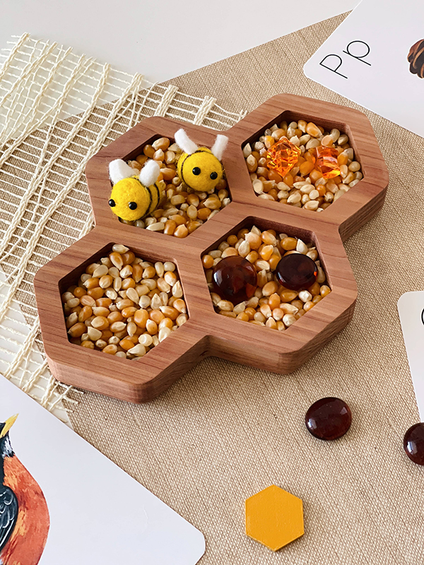 red cedar honey comb shaped sensory bin for kids open ended learning activities