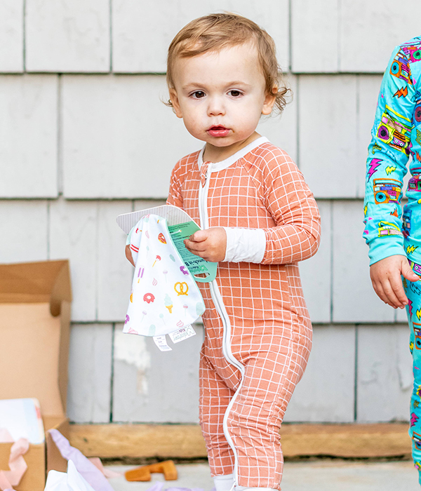 toddler holding a munch it baby lovie blanket from Howdy Baby childrens subscription boxes