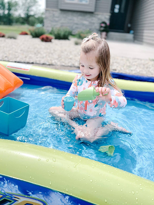 little girl playing in the water with eco friendly beach toys