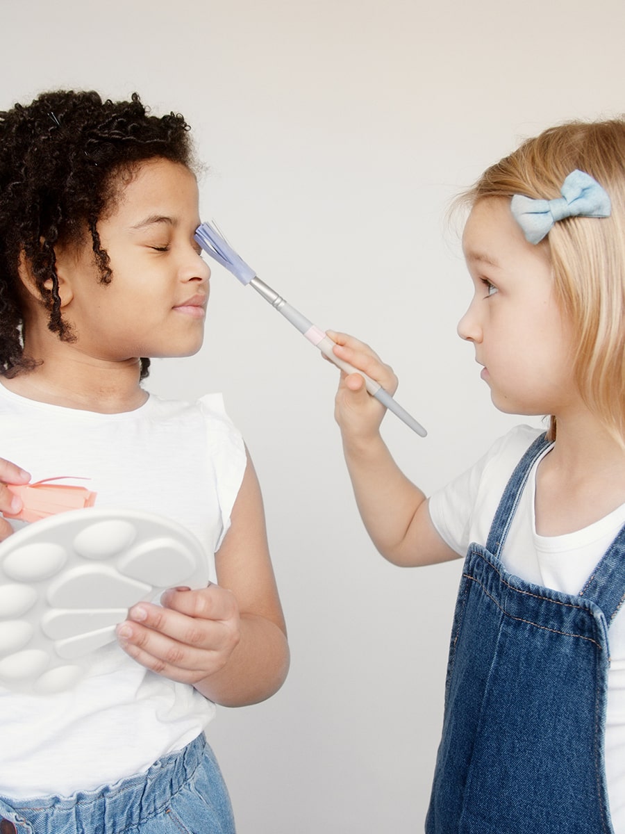 little girls painting their faces