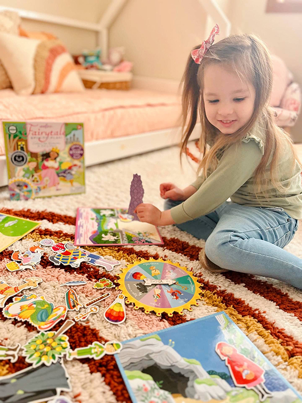 little girl playing a fairytale spinner game