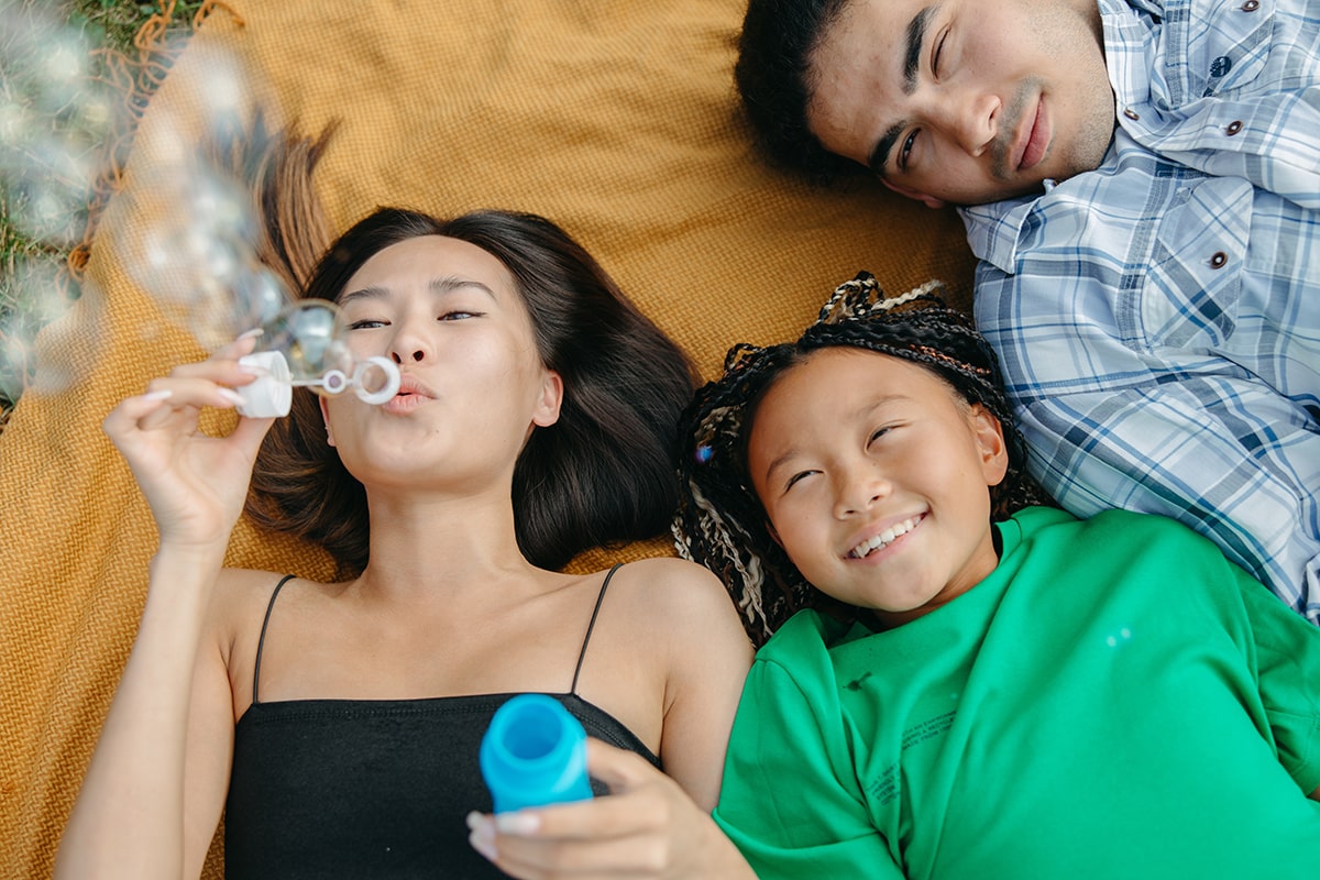 family blowing bubbles together