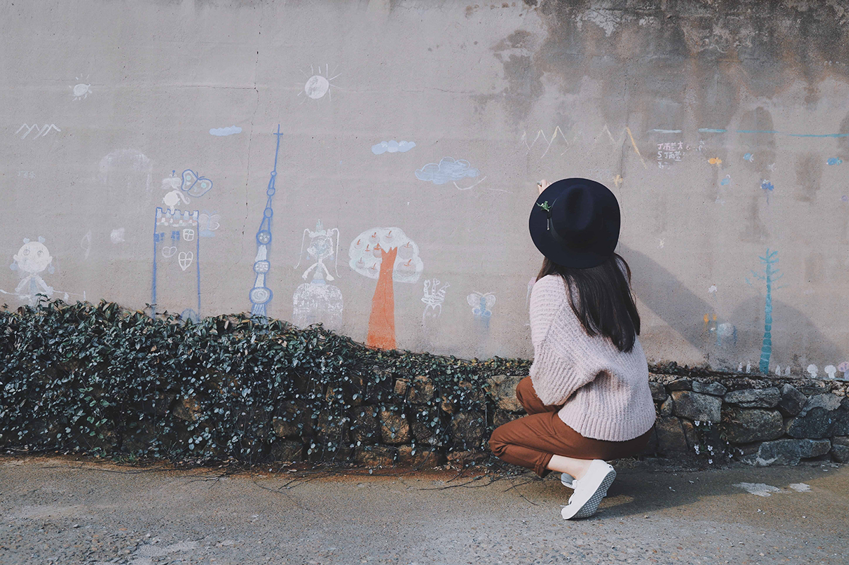 little girl playing games with sidewalk chalk