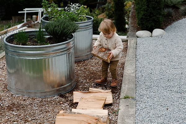 toddler girl playing in the garden