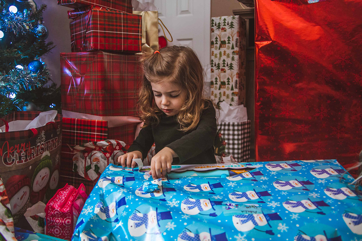 little girl opening gift