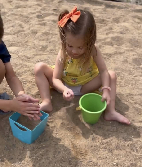 girl playing in sand