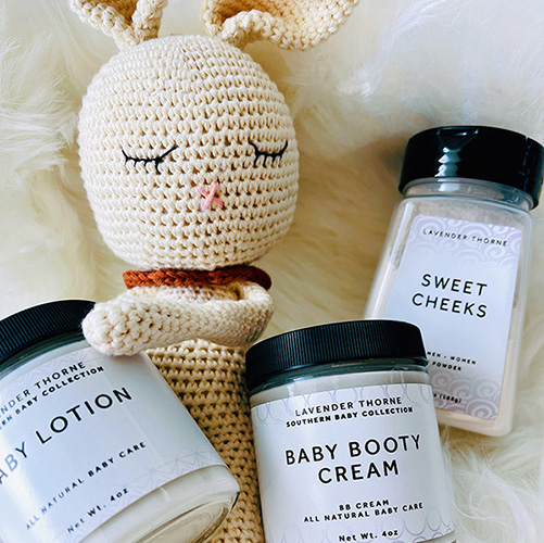 toy bunny holding baby rash cream, baby lotion, and baby powder