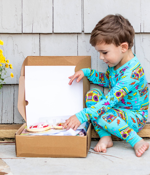 little boy opening his Howdy Kids cooking themed subscription box