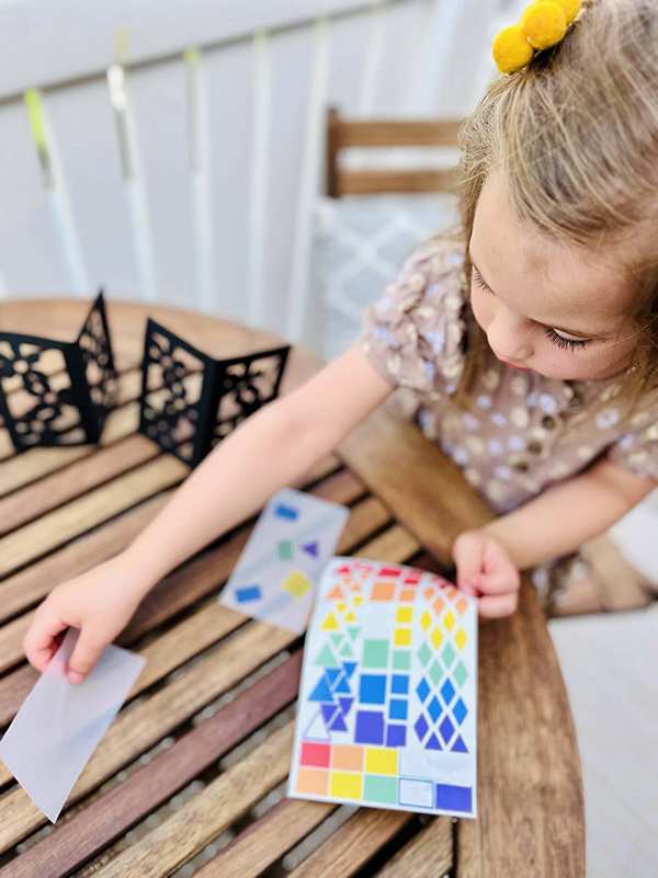 toddler girl using a lantern craft kit