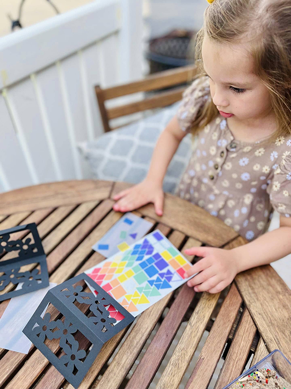 little girl working on her lantern craft kit project