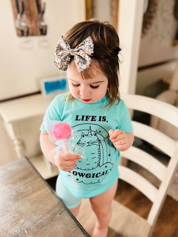 baby girl wearing a life is meowgical toddler t-shirt