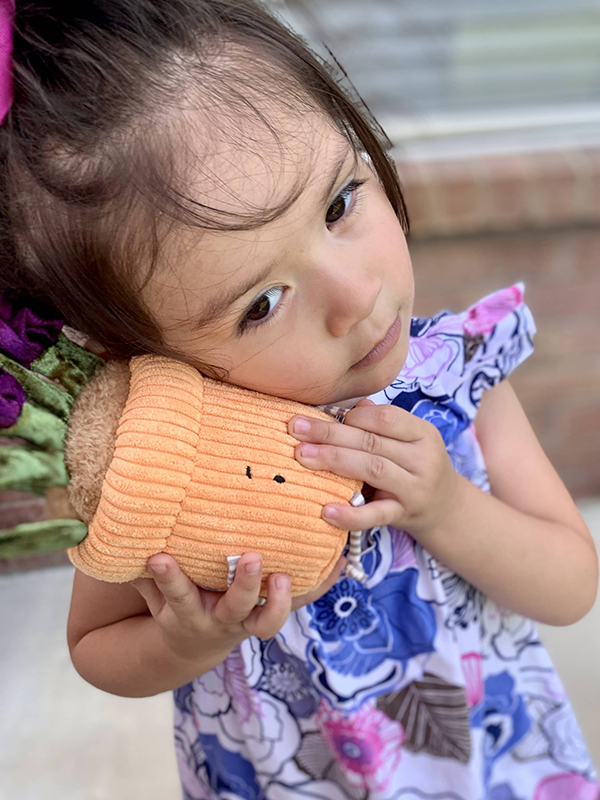 kindergarten girl learning social emotional skills through plushie manipulatives