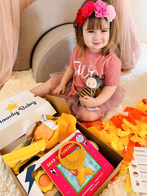 toddler girl exploring the Howdy Baby maternity box subscription