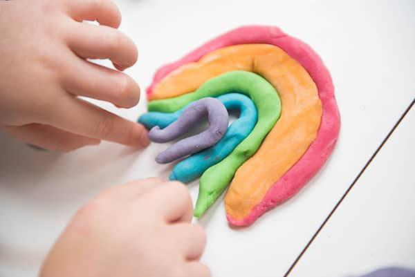 messy little hands molding playdough