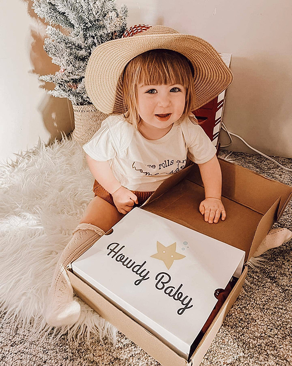 little girl opening her Howdy Baby mommy and me subscription box