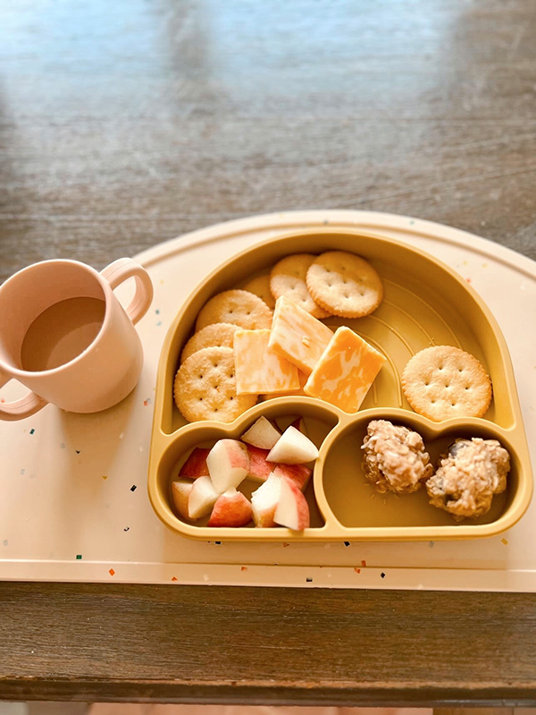 yellow rainbow plate filled with food