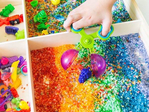 rainbow themed sensory bin for toddlers and preschool aged kids