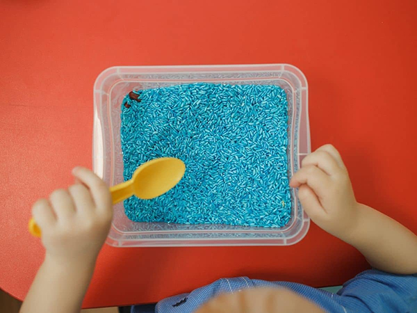 blue sensory bin filler rice