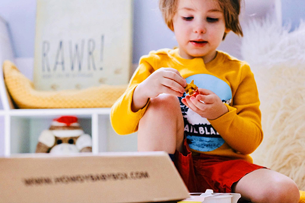 toddler playing with sensory bin toys