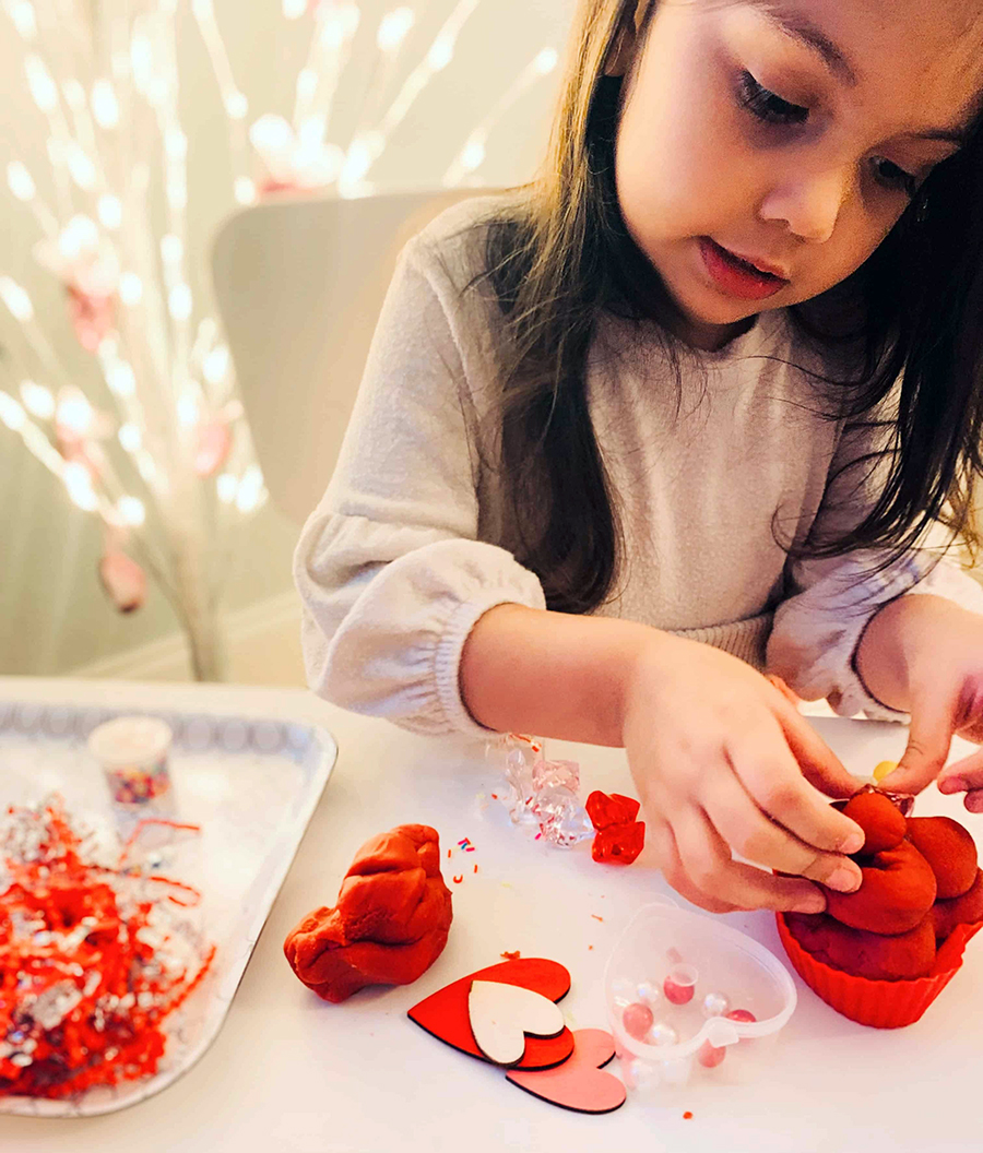 little girl molding sensory kit dough from the Howdy Kids subscription box